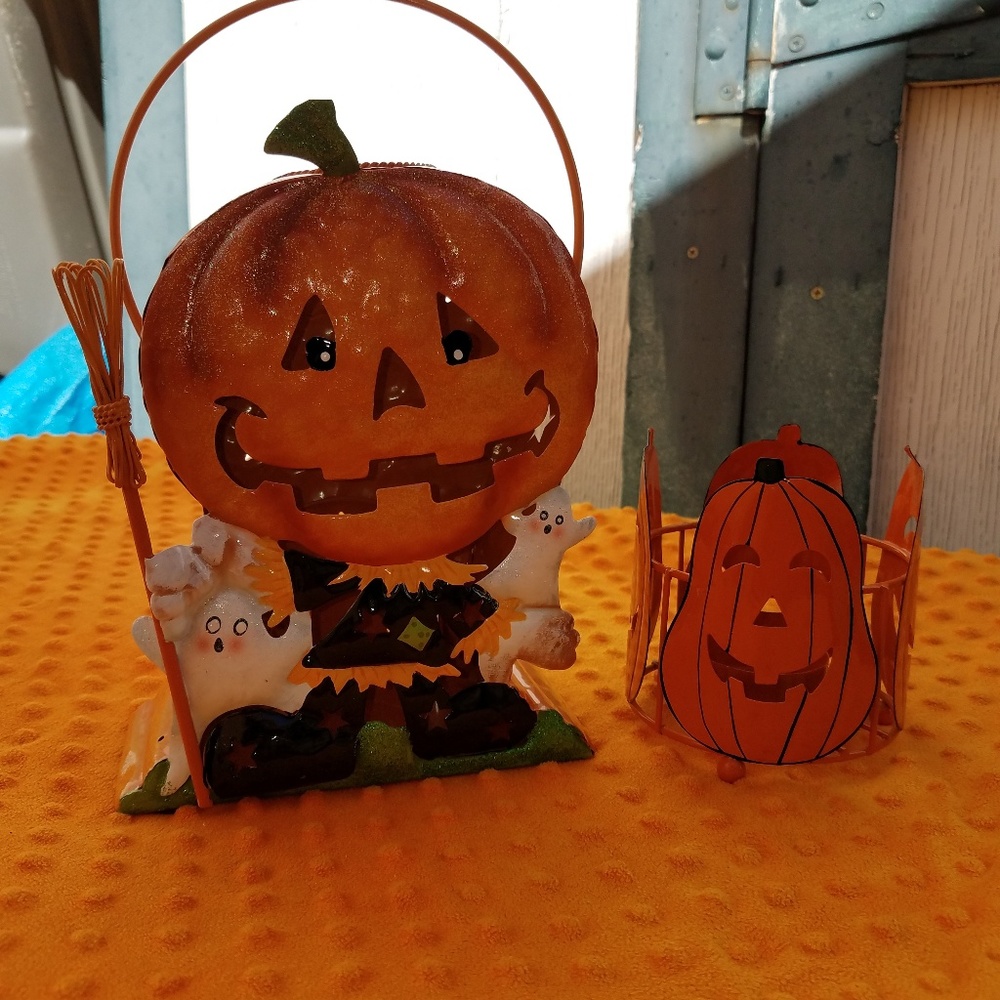 Two Halloween decorations that hold tealights